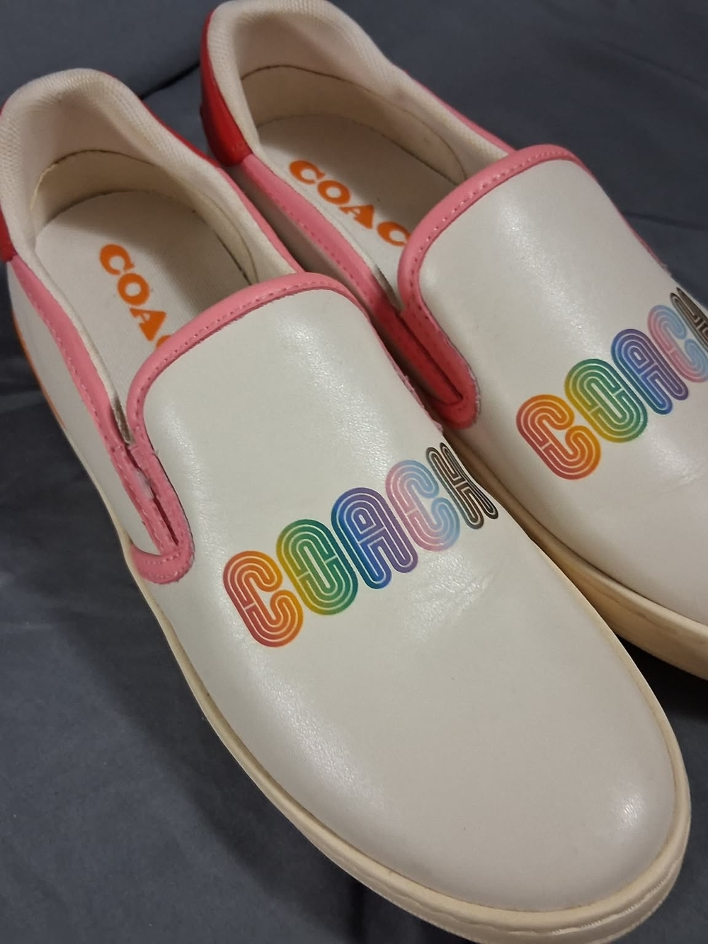 Keds White Slip-On Shoes with Pink Trim and Rainbow COACH Logo